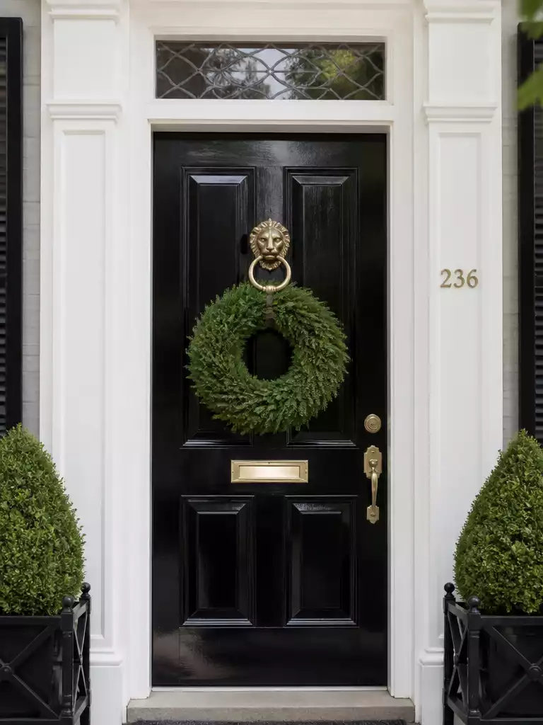 Cypress wreath with three-dimensional sculptural greenery on front door